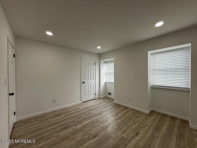 23 Primrose Lane Brick, NJ 08724 - Photo 11 of 22 a view of an empty room with wooden floor and a window