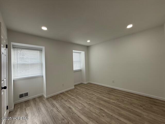 23 Primrose Lane Brick, NJ 08724 - Photo 12 of 22 an empty room with wooden floor and windows