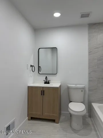 a bathroom with a toilet a sink and bathtub