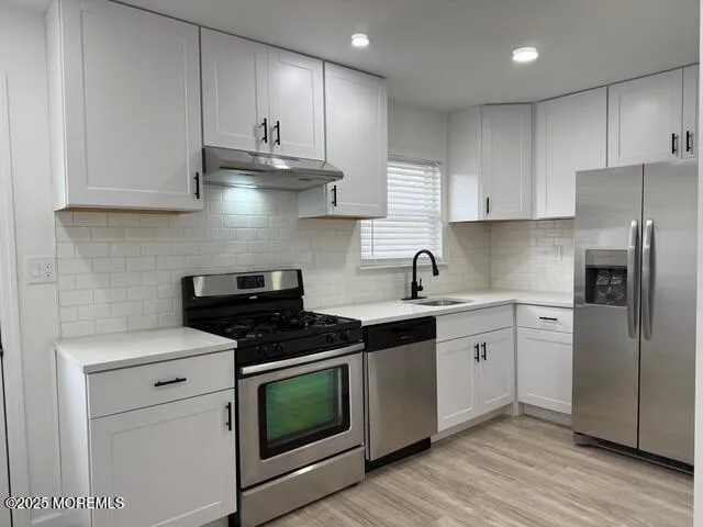 a kitchen with a sink and a stove