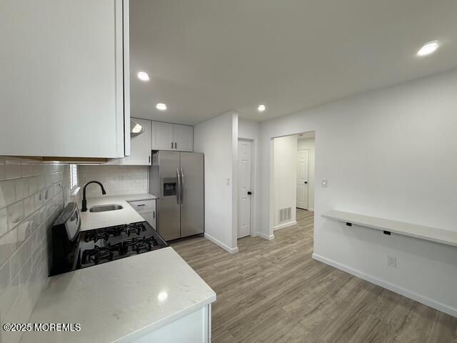 23 Primrose Lane Brick, NJ 08724 - Photo 9 of 22 a kitchen with a sink and a stove