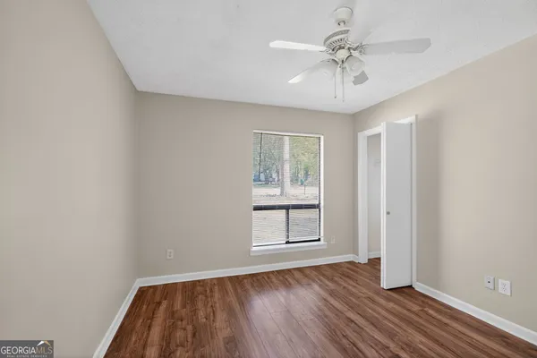 wooden floor in an empty room with a window
