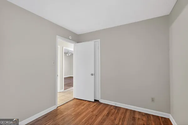 a view of an empty room with wooden floor