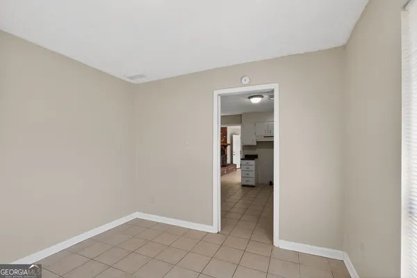 a view of a hallway with wooden shelves