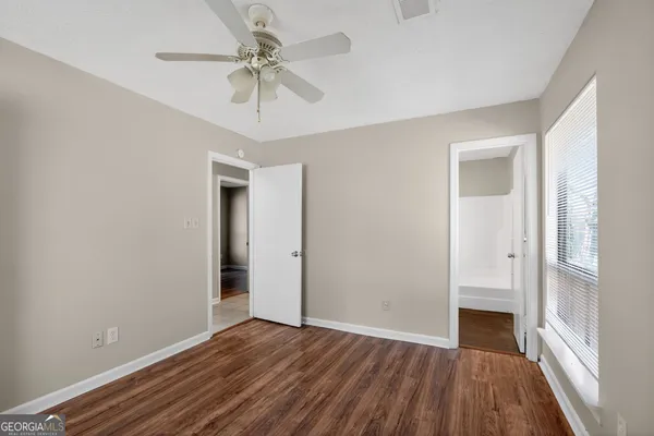 wooden floor in an empty room with a window