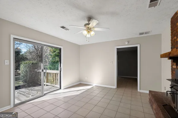 a view of an empty room with glass door
