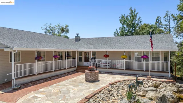 a view of a house with a wooden deck