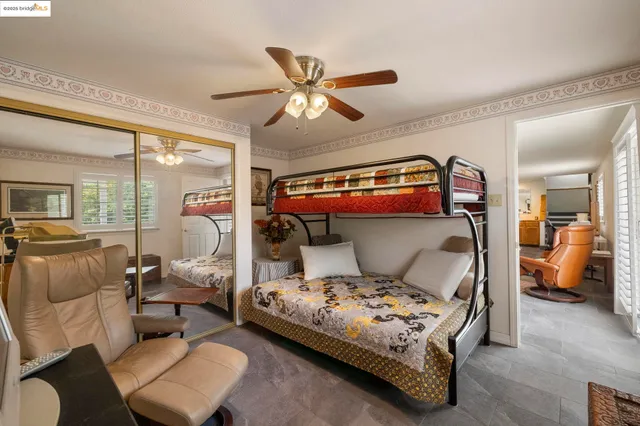 a bedroom with a bed and glass walk in closet