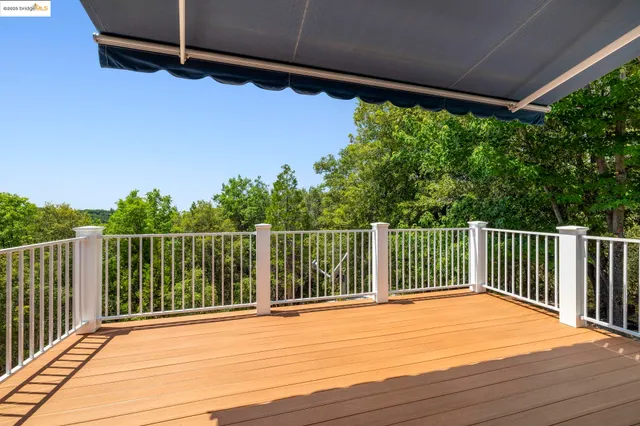 a view of a balcony with yard