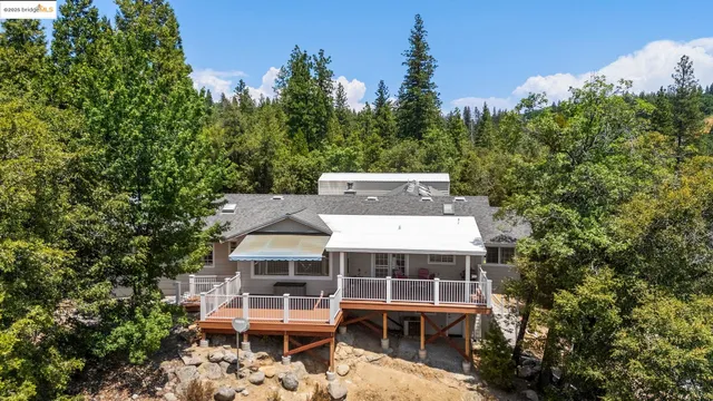 an aerial view of a house with a yard