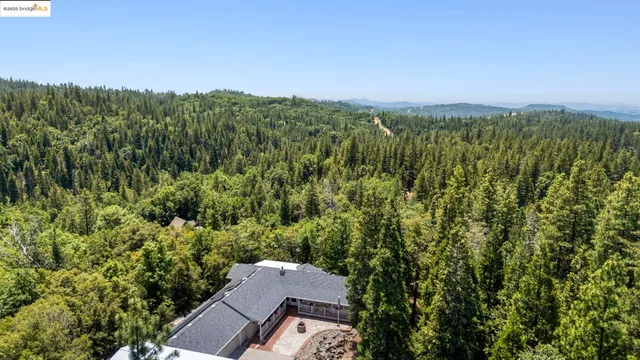 an aerial view of a house with a yard