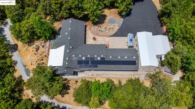 an aerial view of a house with yard swimming pool and outdoor seating