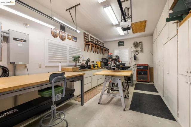 a kitchen with sink cabinets and stove top oven