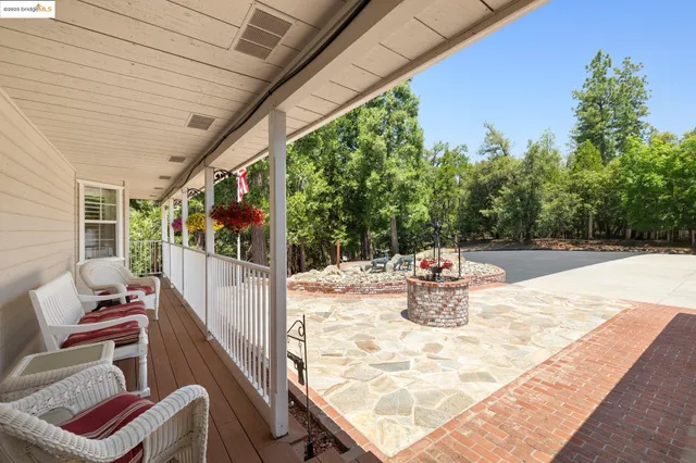 a view of a chairs and tables in the back yard of the house