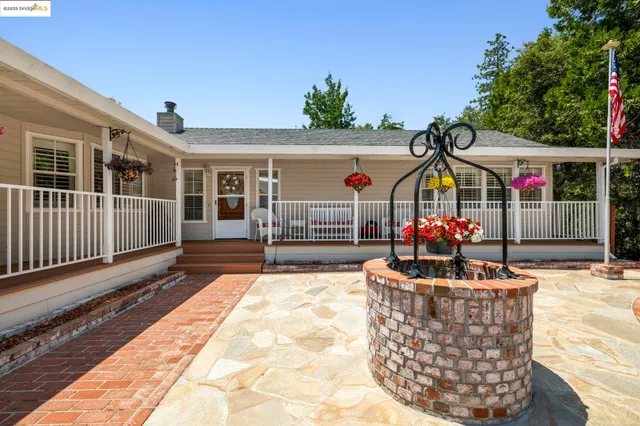 a front view of a house with basket ball court and glass windows
