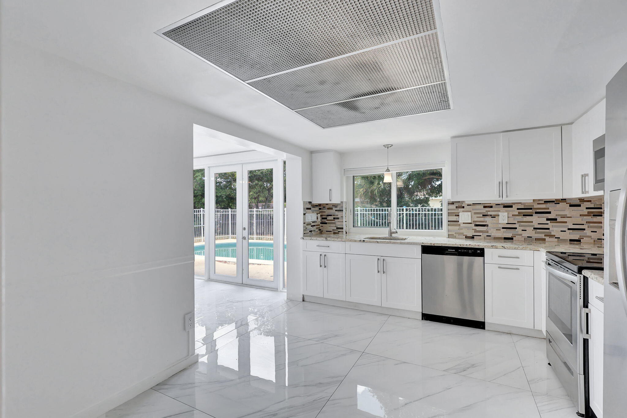 334 Southwest 13th Avenue Boynton Beach, FL 33435 - Photo 14 of 41 a kitchen with a sink cabinets and window