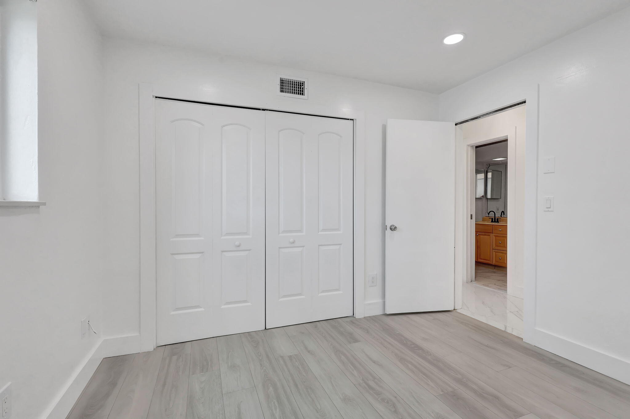 334 Southwest 13th Avenue Boynton Beach, FL 33435 - Photo 21 of 41 an empty room with wooden floor and closet area
