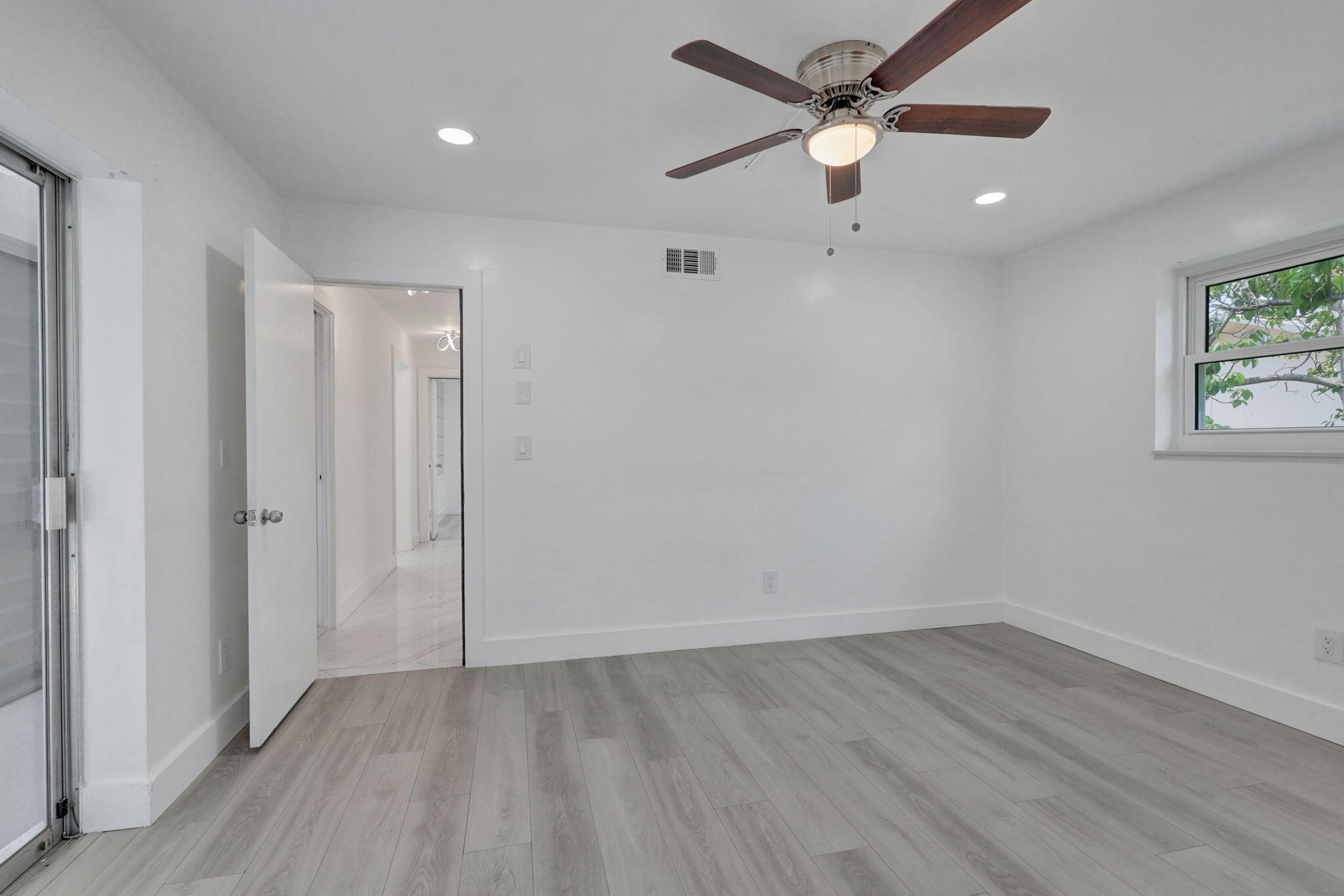 334 Southwest 13th Avenue Boynton Beach, FL 33435 - Photo 23 of 41 wooden floor in an empty room with a window
