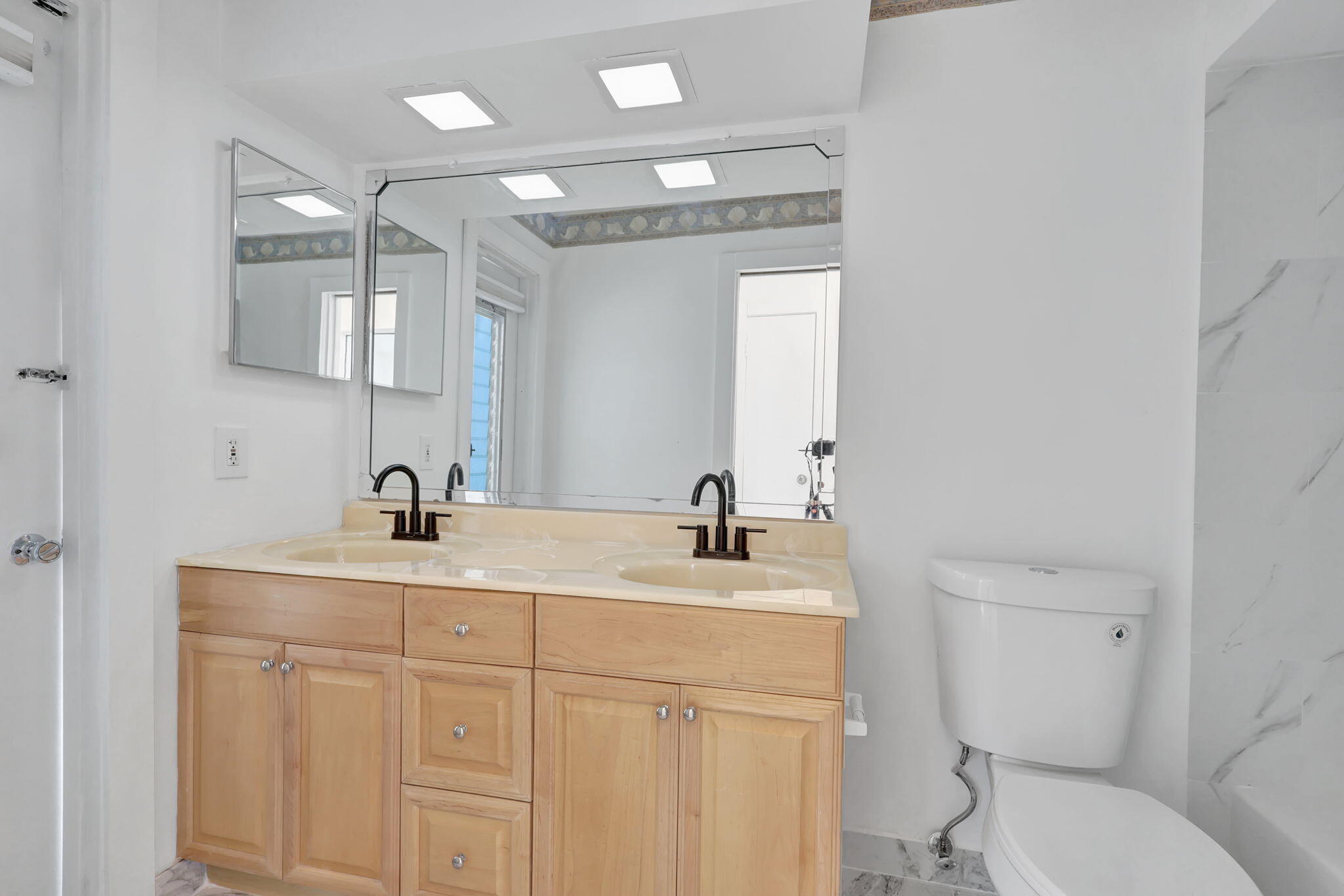 334 Southwest 13th Avenue Boynton Beach, FL 33435 - Photo 27 of 41 a bathroom with a sink a toilet and mirror