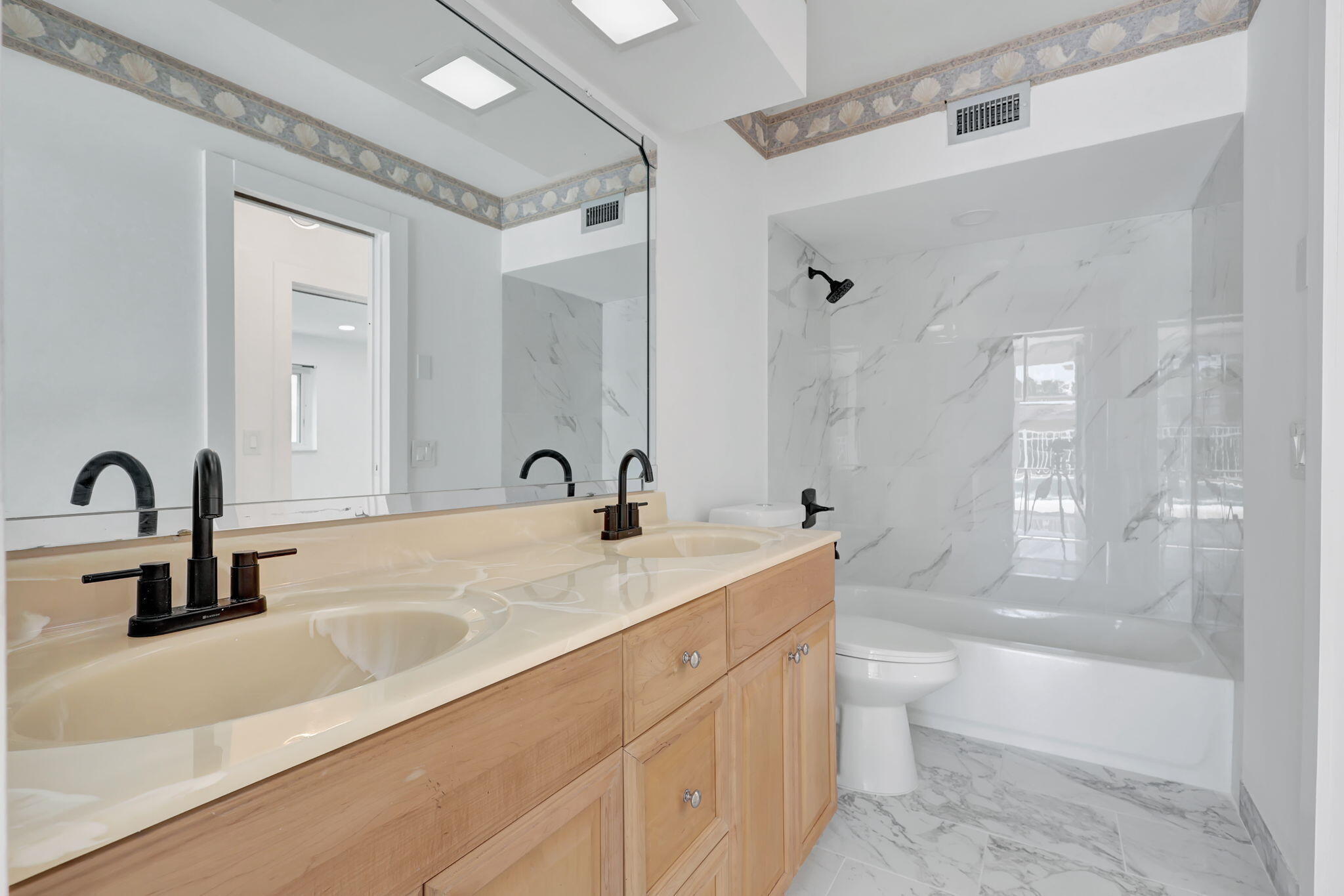 334 Southwest 13th Avenue Boynton Beach, FL 33435 - Photo 28 of 41 a bathroom with a double vanity sink a mirror and a bathtub