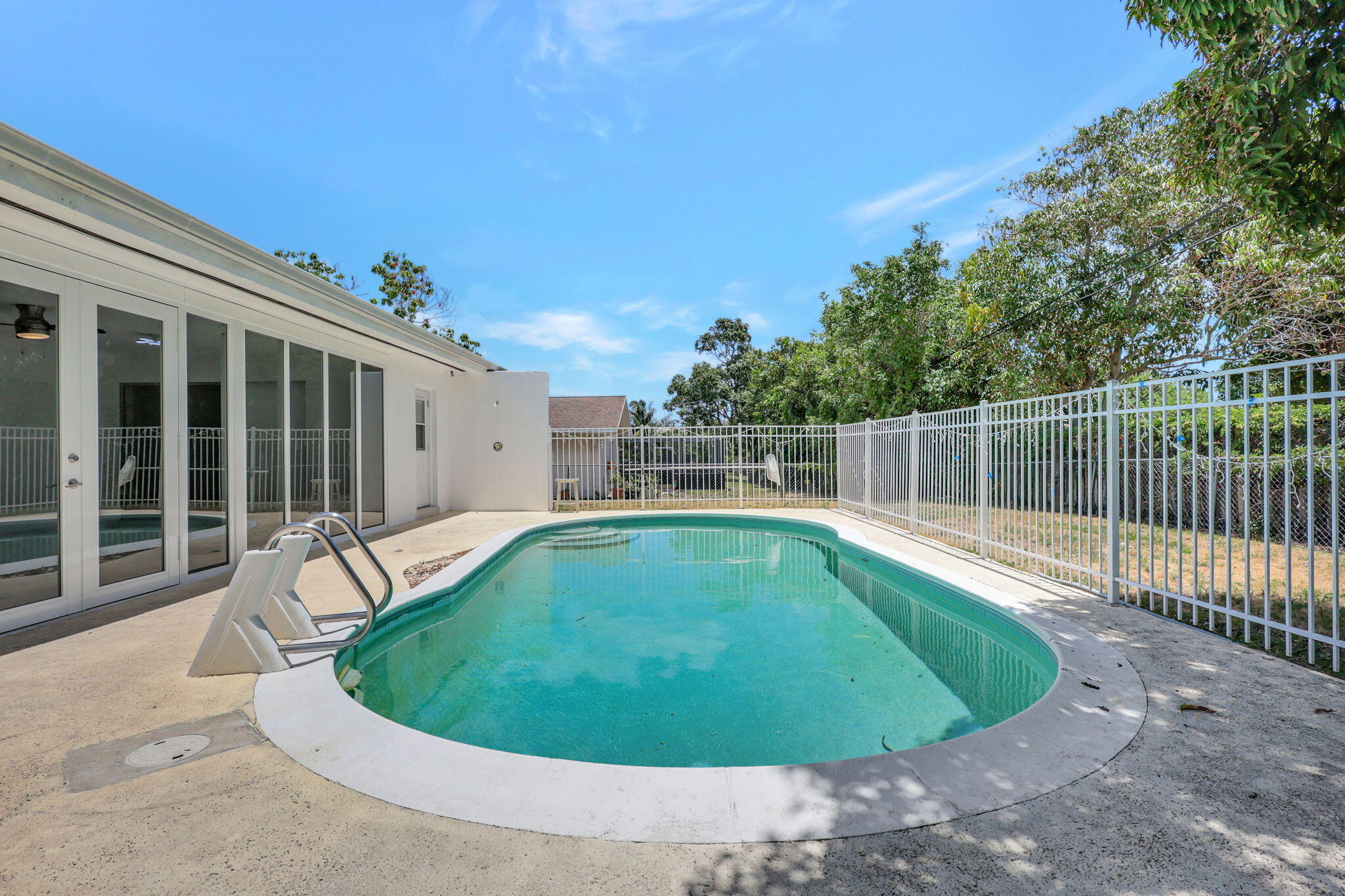 334 Southwest 13th Avenue Boynton Beach, FL 33435 - Photo 34 of 41 a view of a swimming pool with a patio