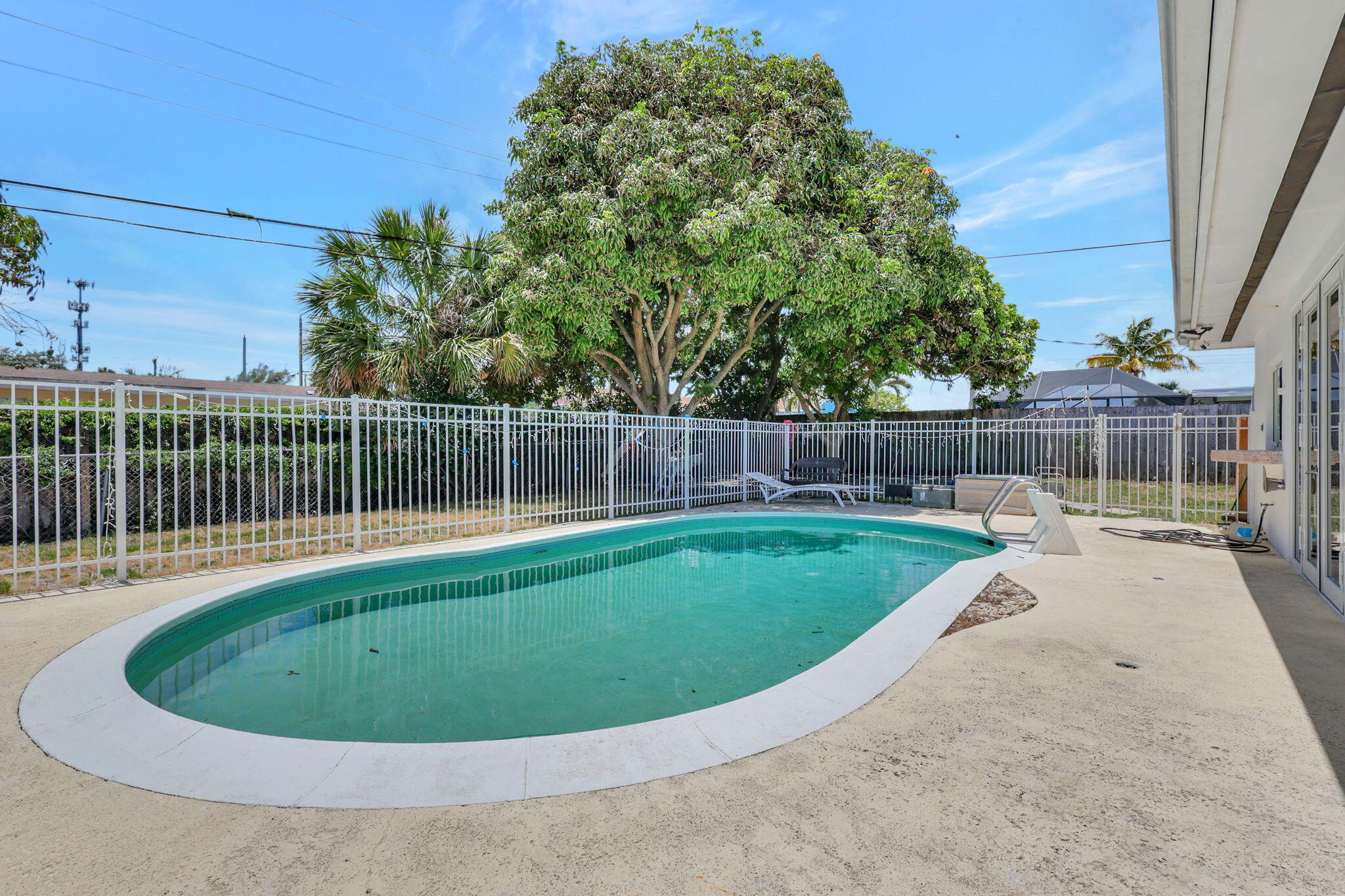 334 Southwest 13th Avenue Boynton Beach, FL 33435 - Photo 35 of 41 a view of a backyard with a small cabin and wooden fence