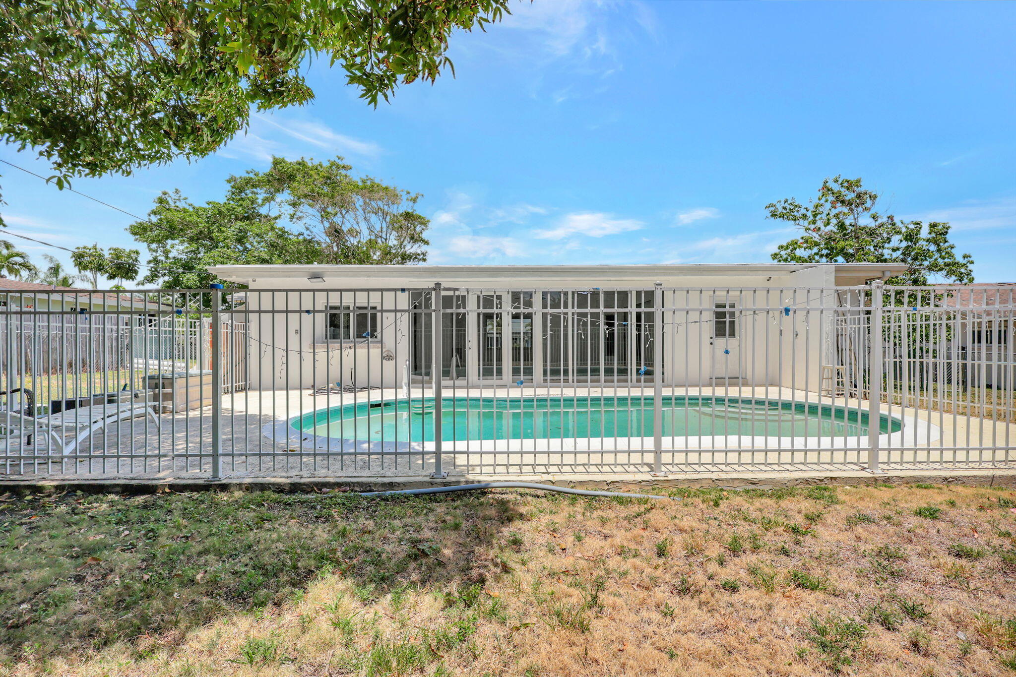 334 Southwest 13th Avenue Boynton Beach, FL 33435 - Photo 36 of 41 a view of a yard with wooden fence