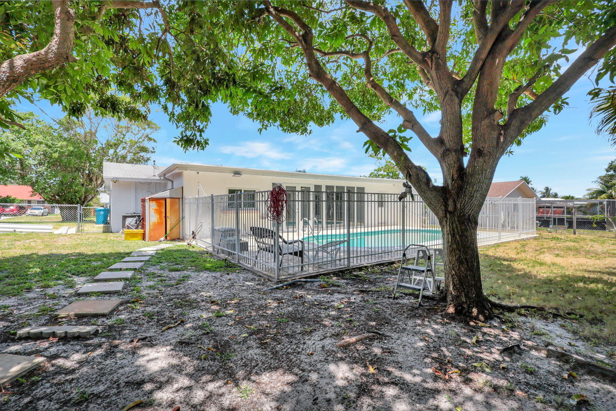 334 Southwest 13th Avenue Boynton Beach, FL 33435 - Photo 5 of 41 a view of a house with backyard and a tree