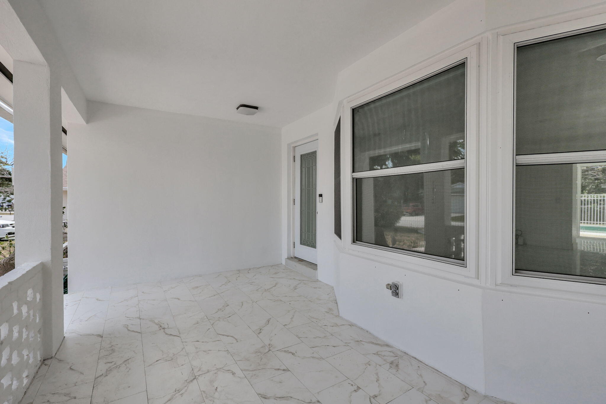 334 Southwest 13th Avenue Boynton Beach, FL 33435 - Photo 6 of 41 a view of an empty room with wooden floor and a window