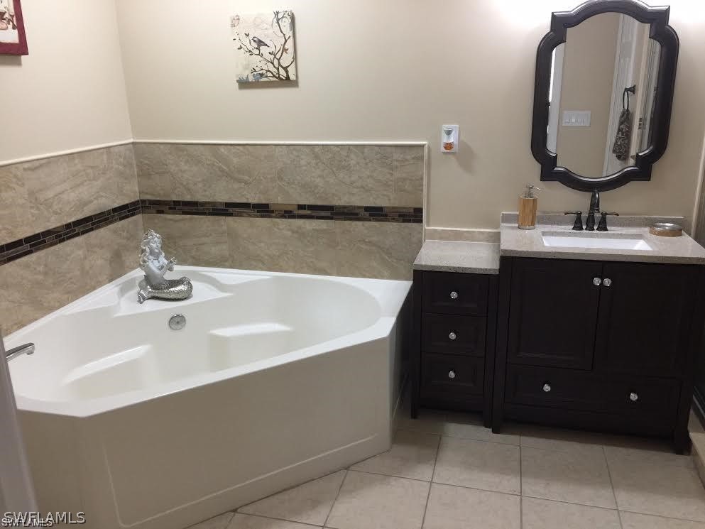 239 Rue Labonne Road Fort Myers, FL 33913 - Photo 19 of 22 a bathroom with a double vanity sink and a mirror