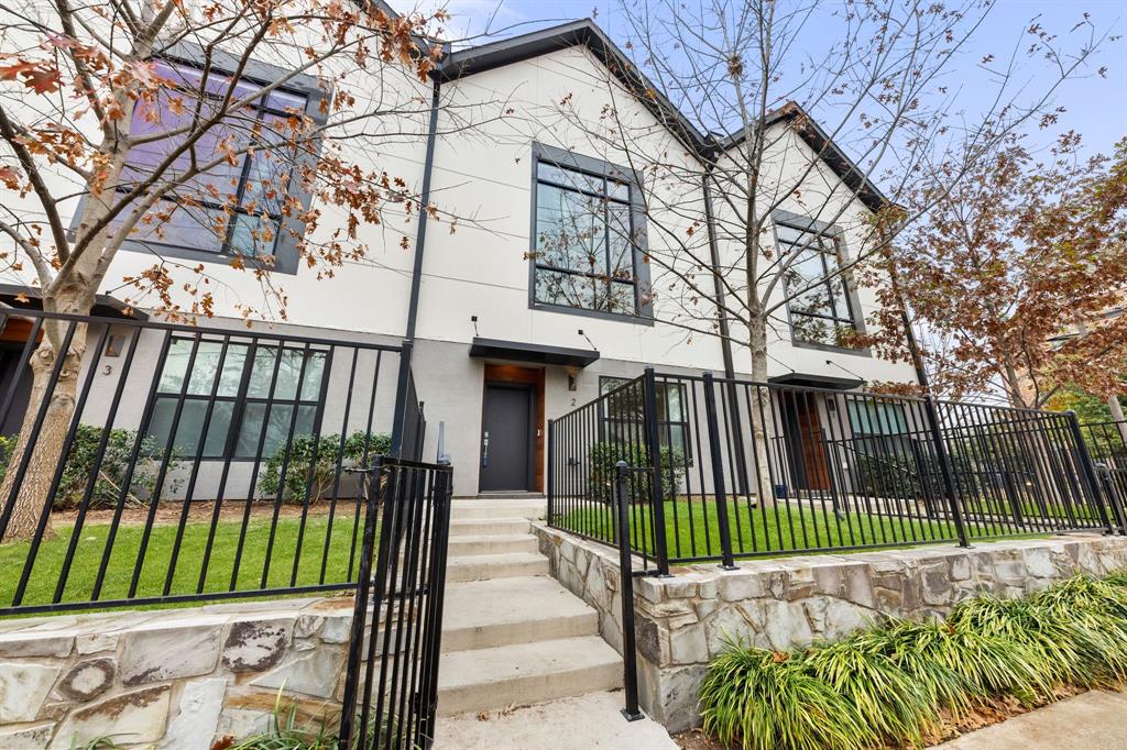 3880 Munger Avenue, Unit 2 Dallas, TX 75204 - Photo 2 of 29 a view of a brick house with a small yard and wooden fence
