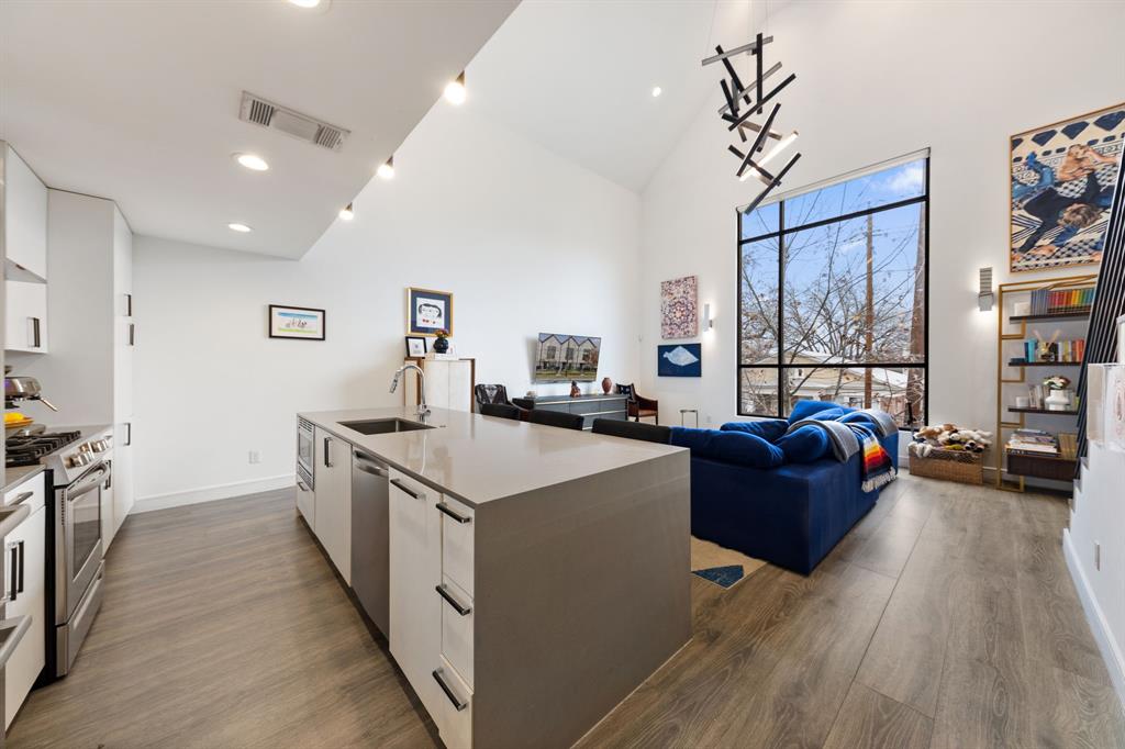 3880 Munger Avenue, Unit 2 Dallas, TX 75204 - Photo 5 of 29 a kitchen with stainless steel appliances granite countertop a lot of counter space and wooden floor