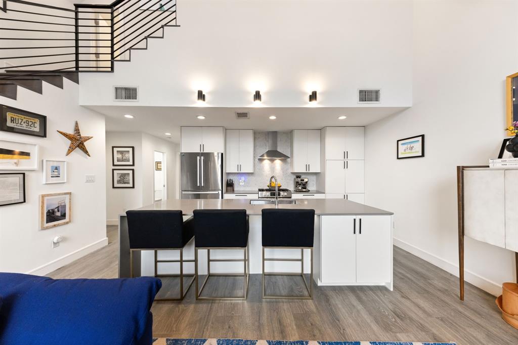 3880 Munger Avenue, Unit 2 Dallas, TX 75204 - Photo 8 of 29 a living room with stainless steel appliances kitchen island a table chairs and a kitchen view