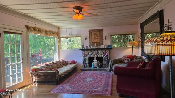 a view of a dining room with furniture window and wooden floor