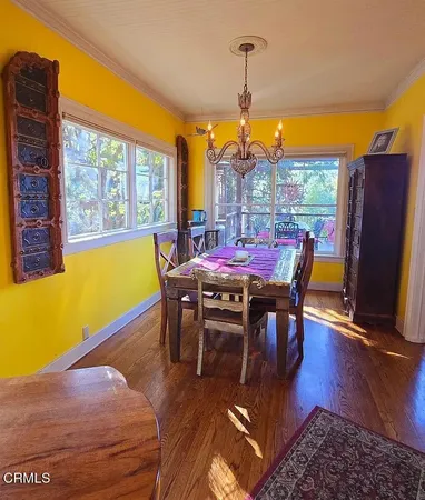 a bedroom with a bed a chandelier and a window