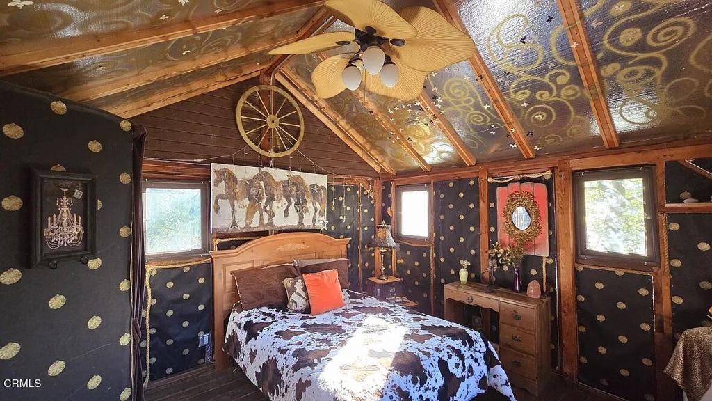 1450 McAndrew Road Ojai, CA 93023 - Photo 15 of 58 a bedroom with a bed a chandelier and a window