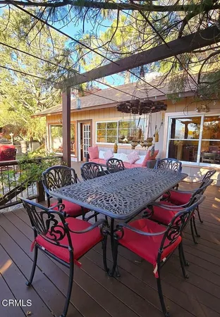a view of a patio with a table and chairs under an umbrella