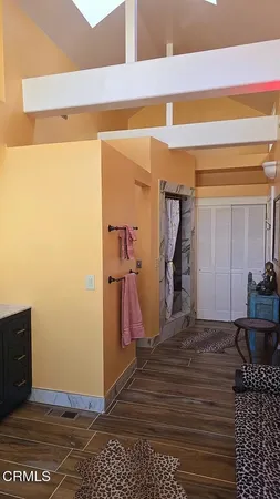 an outdoor sitting area with furniture and wooden floor