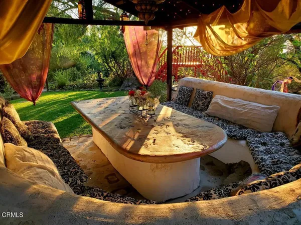 a view of balcony with wooden floor and outdoor seating