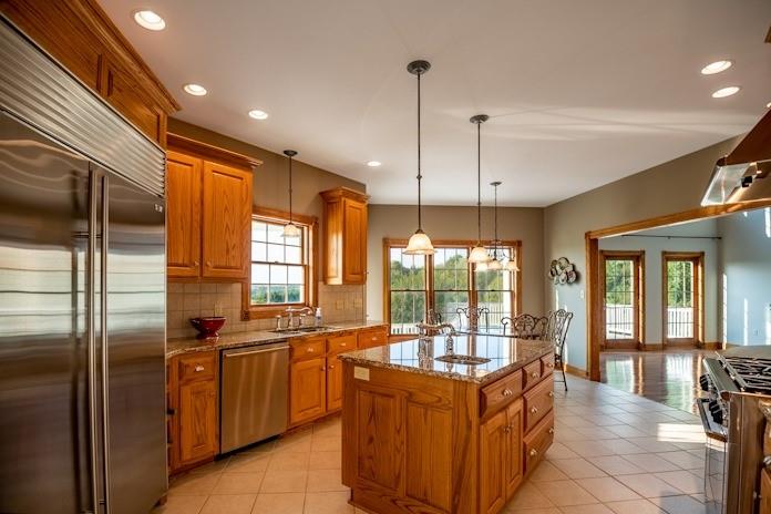 463 Gerber Road Volant, PA 16156 - Photo 9 of 25 a kitchen with stainless steel appliances granite countertop a stove a sink and a refrigerator