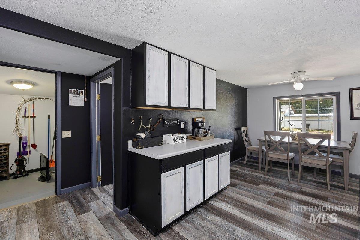 418 South Date Street Shoshone, ID 83352 - Photo 14 of 36 Integrated counter space featuring white upper cabinetry and black lower cabinetry with white paneling