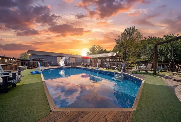 a view of a swimming pool with lounge chairs