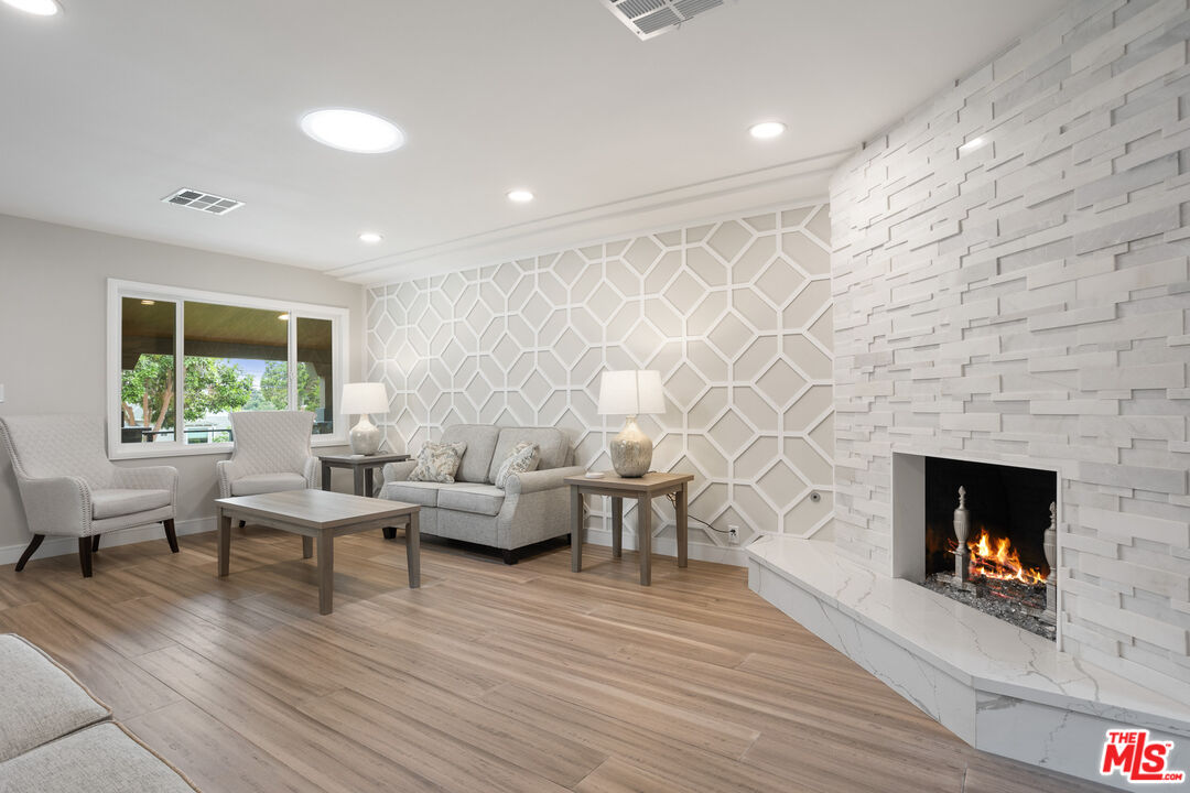 393 Allendale Road Pasadena, CA 91106 - Photo 11 of 75 a living room with furniture and a fireplace