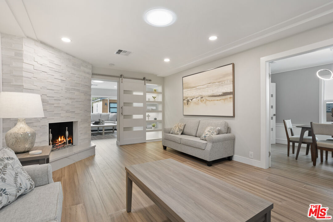 393 Allendale Road Pasadena, CA 91106 - Photo 12 of 75 a living room with furniture and a fireplace