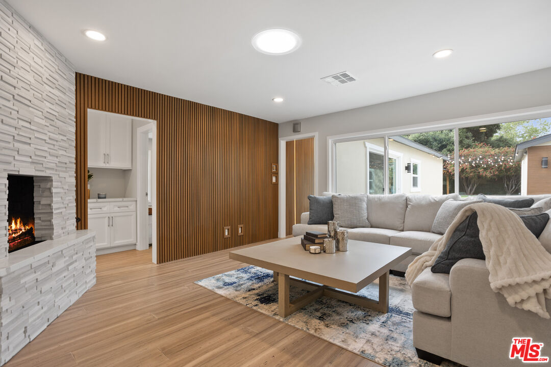 393 Allendale Road Pasadena, CA 91106 - Photo 20 of 75 a living room with furniture and a fireplace