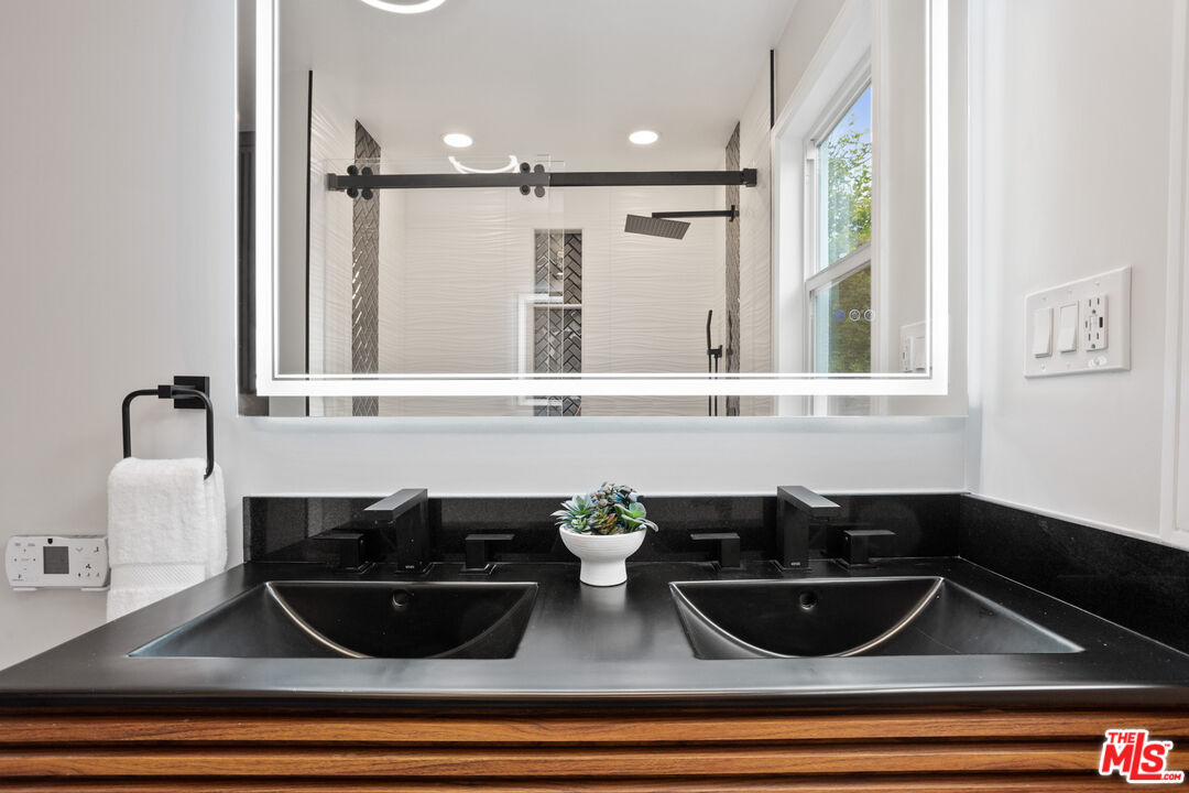 393 Allendale Road Pasadena, CA 91106 - Photo 30 of 75 a table with a potted plant and a sink