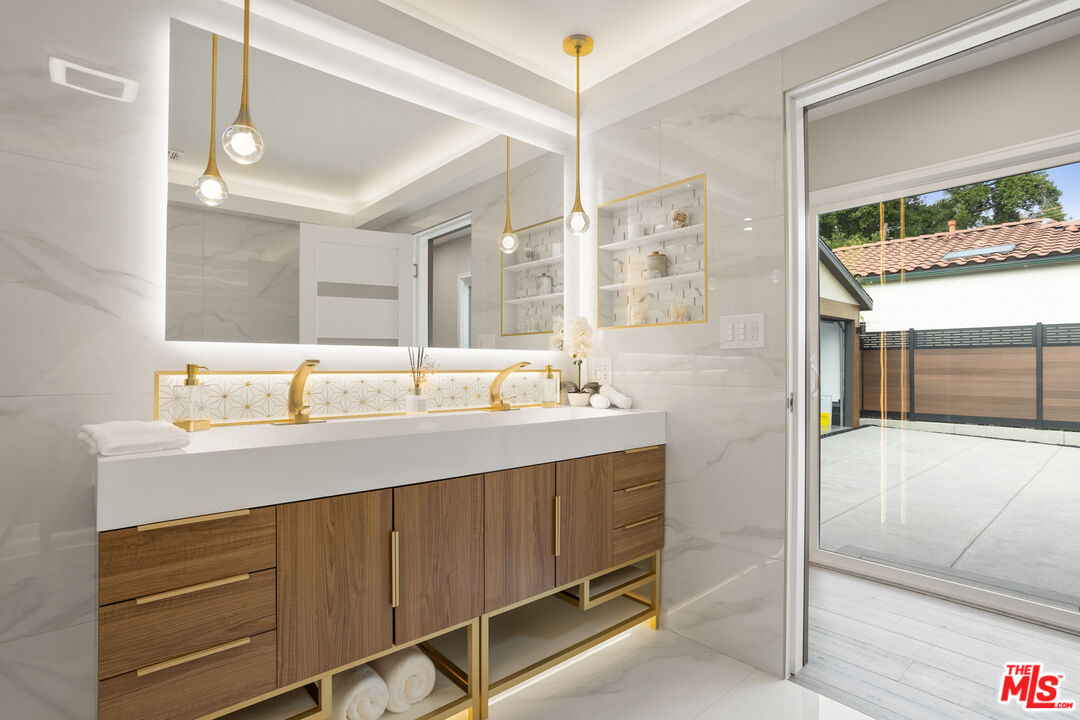 393 Allendale Road Pasadena, CA 91106 - Photo 45 of 75 a bathroom with a double vanity sink a mirror and a shower