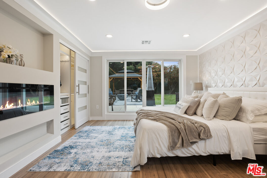 393 Allendale Road Pasadena, CA 91106 - Photo 48 of 75 a large bedroom with a large bed and a large window