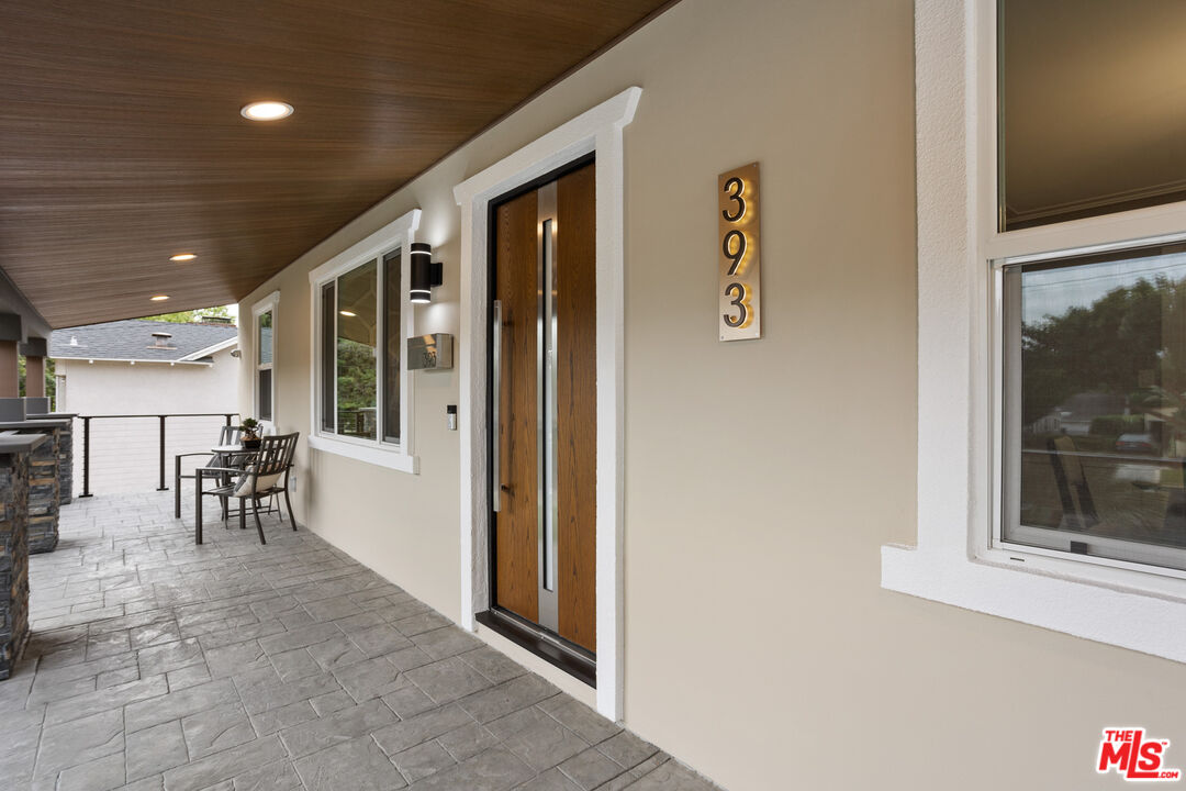 393 Allendale Road Pasadena, CA 91106 - Photo 8 of 75 a view of a hallway with furniture and a dining table
