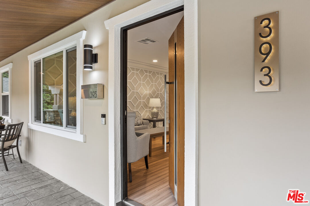 393 Allendale Road Pasadena, CA 91106 - Photo 9 of 75 a view of a hallway with wooden floor and a dining room